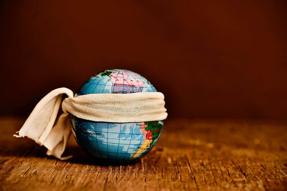 a piece of cloth tied around a terrestrial globe, placed on a rustic wooden surface, bad algorithms miss talent concept