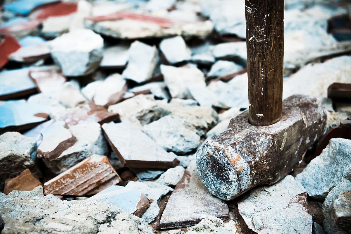 A sledgehammer used to demolish; ; labor shortage concept