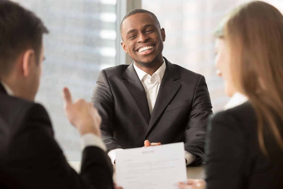 Employer showing thumbs up to successful black candidate at interview, executive boss satisfied with african employee work results, startupper got angel investment funding for business idea, good job