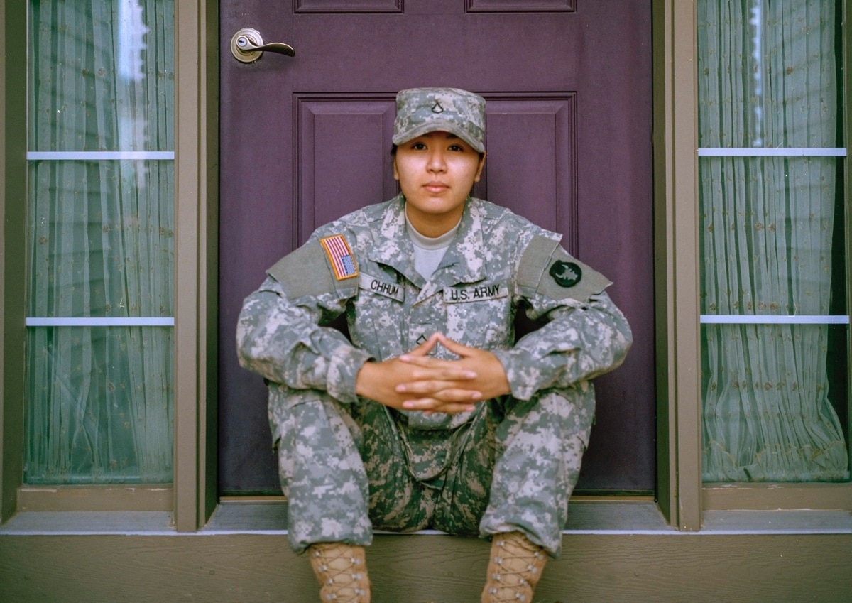 soldier sits on the stoop of their front door; army talent management concept