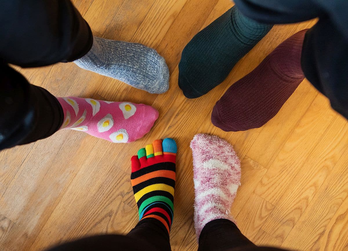 Funny family legs in mismatched socks; hire for skills concept