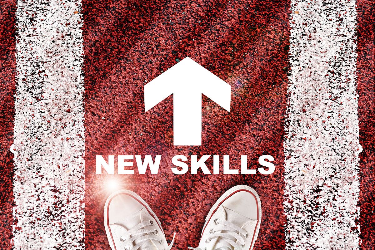 The words 'new skills' and a white arrow written on road surface with marking lines; talent intelligence helps banks concept