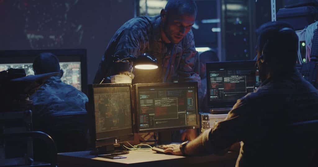 Medium shot of a soldier working on a computer; DOD, AI, military reserves concept