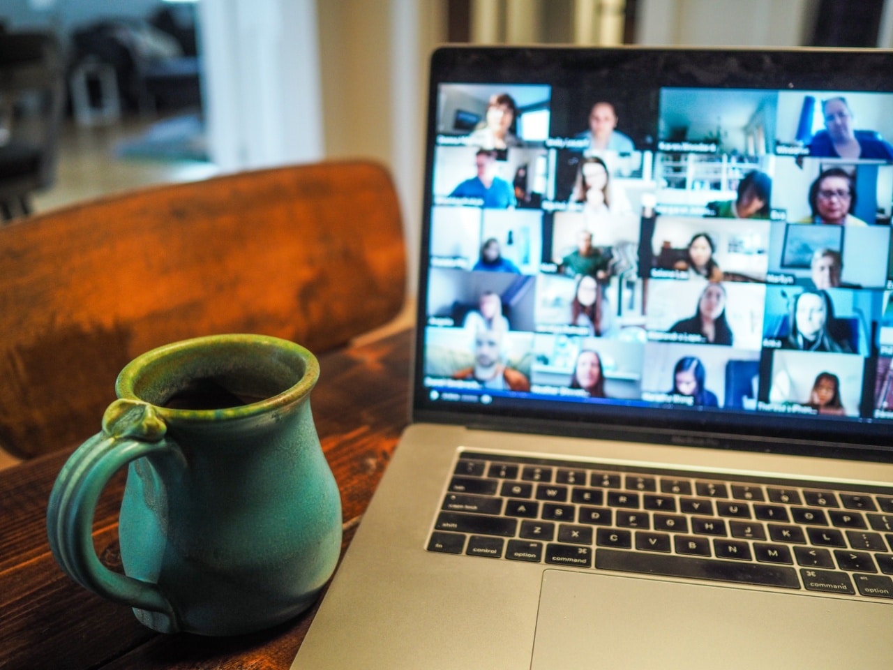open laptop displaying a videochat meeting; talent management insurance concept