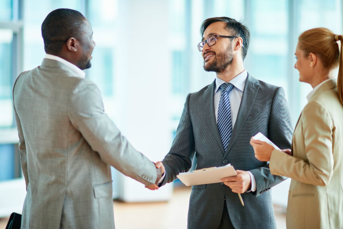 Two businessman shaking hands; employer branding experts concept