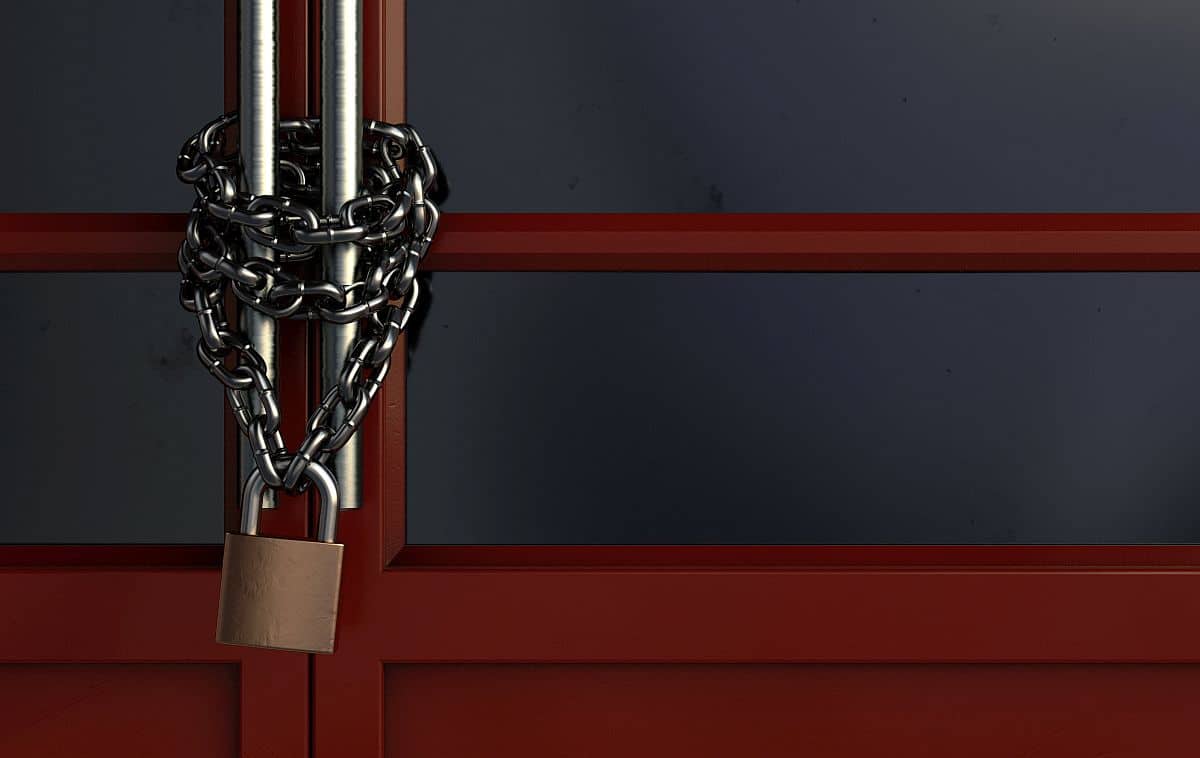 A red generic storefont door chained shut and locked with a chain an padlock - 3D render
