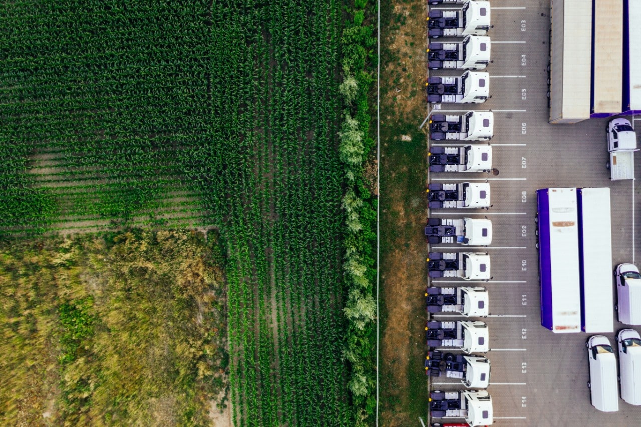 overhead shot of shipping and delivery trucks; DEI in logistics concept